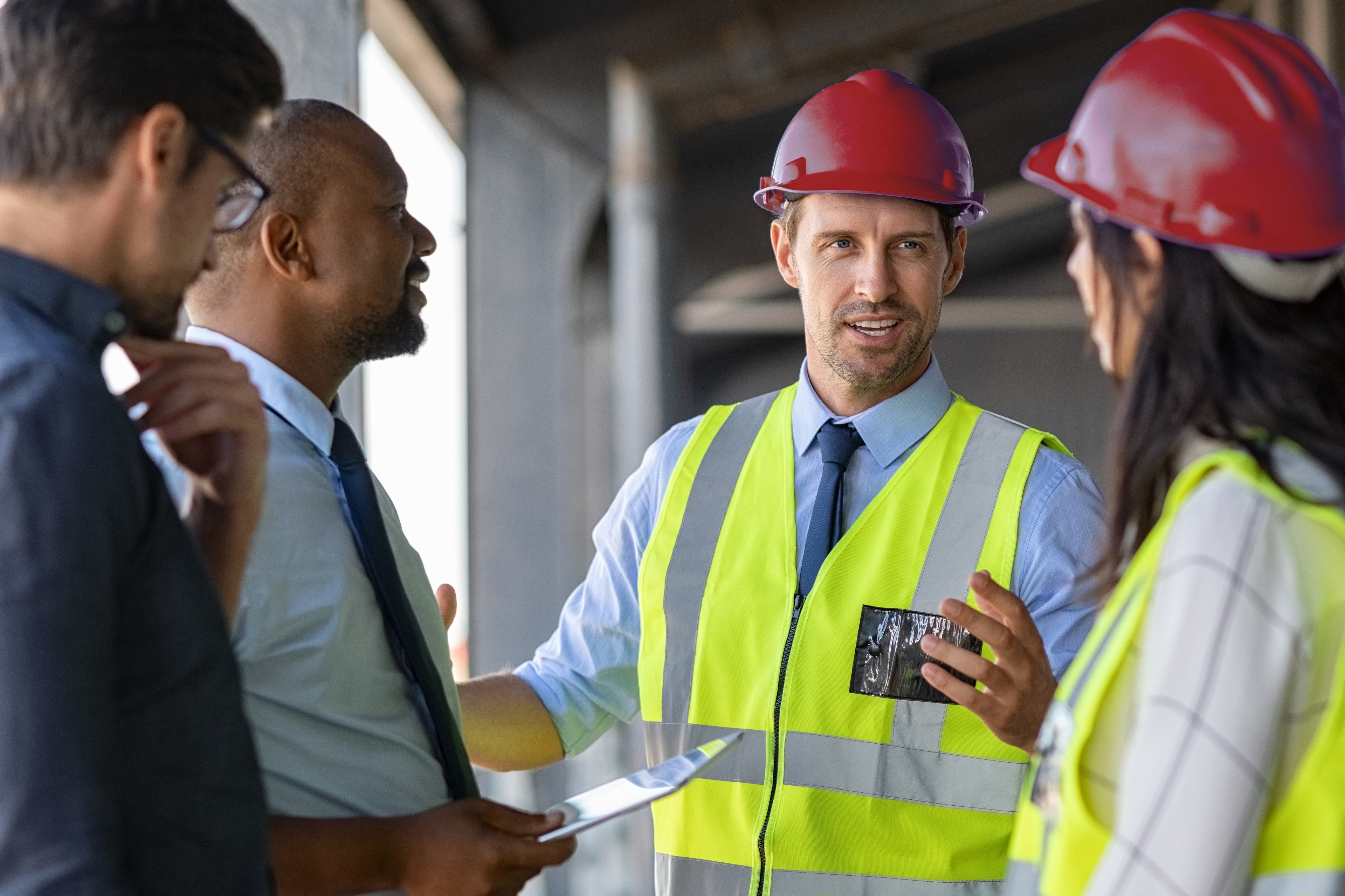 Image of 2 engineers sharing expertise to share holders