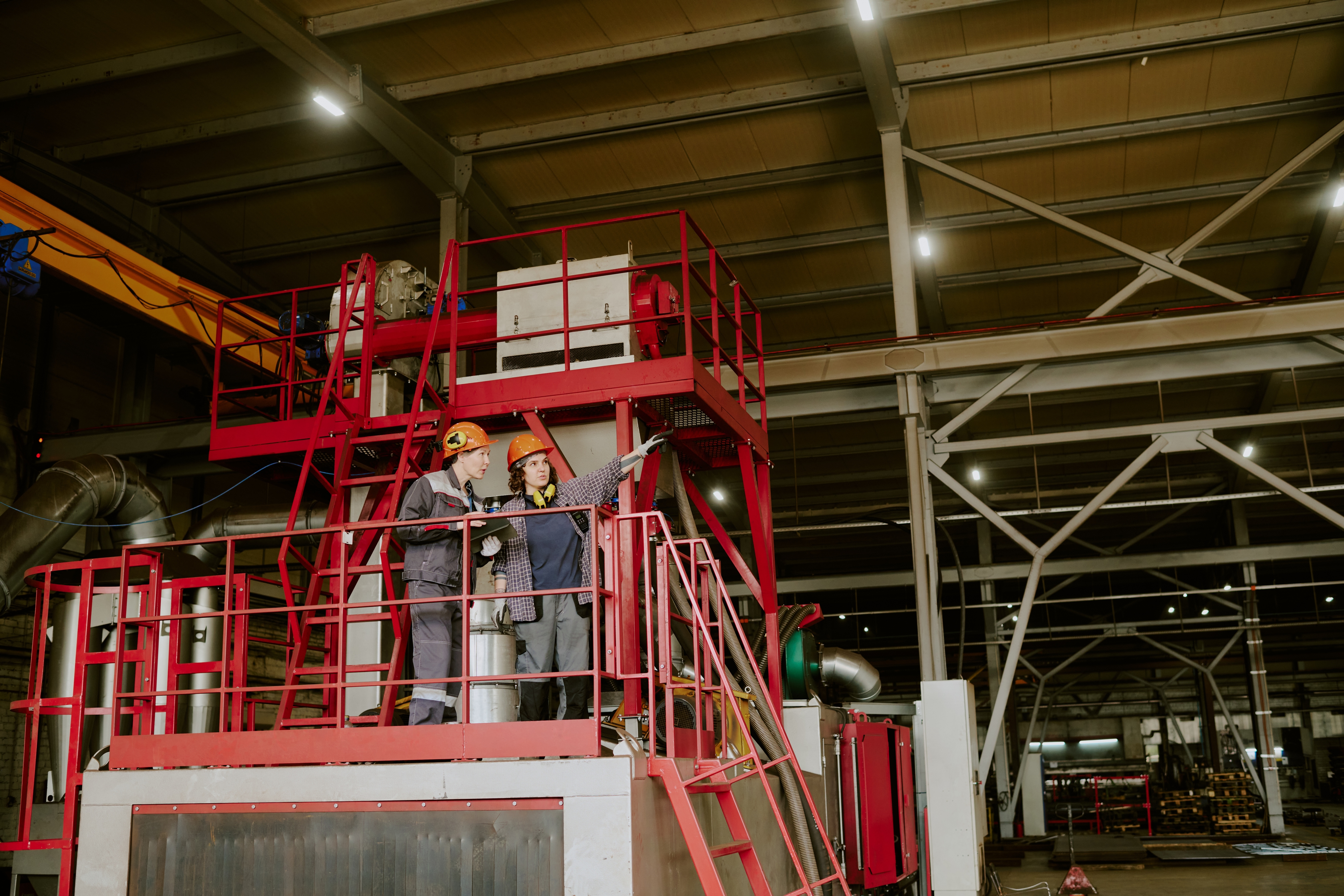 Two engineers standing on a mining platform and pointing