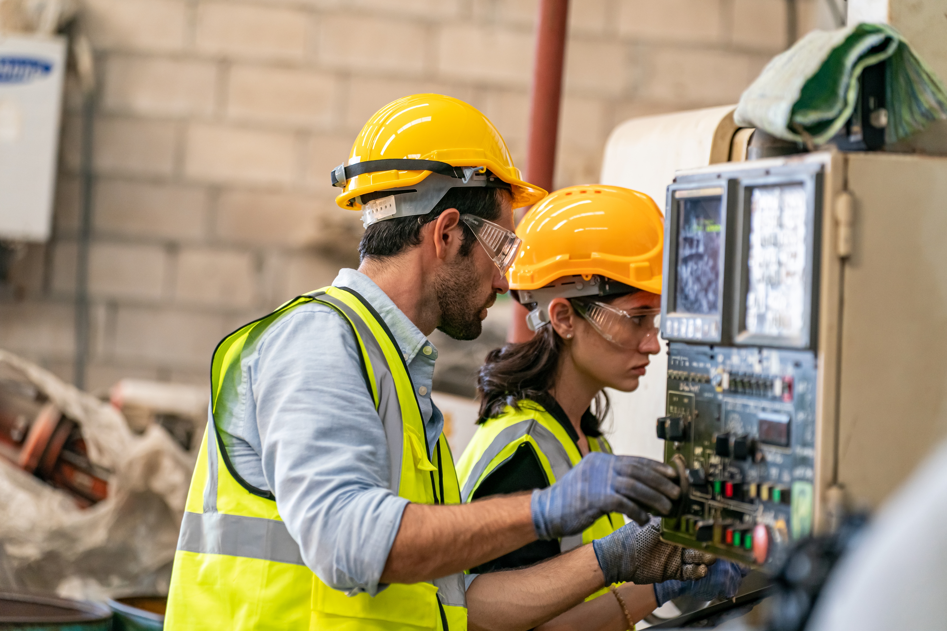 An image of a two experienced engineers working on a machine in a progressive team